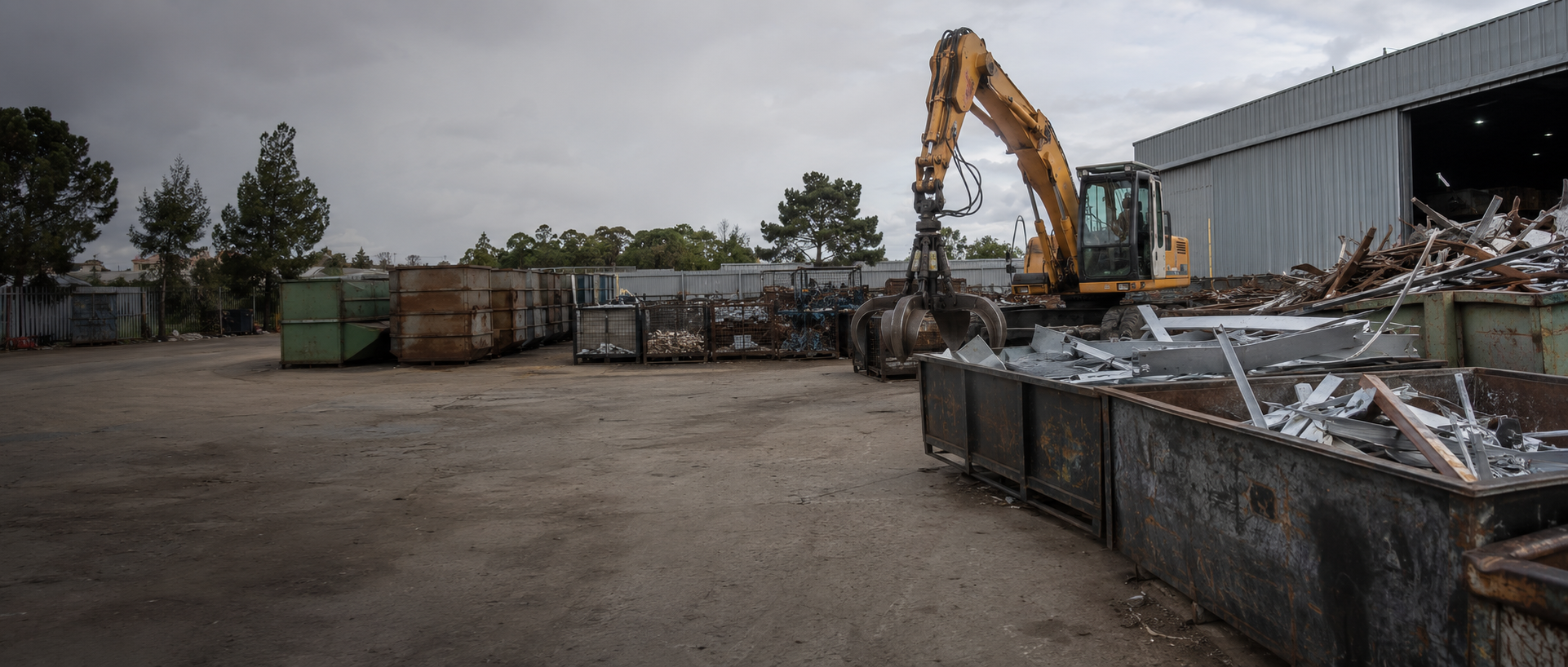 Kidd Metals scrap metal recycling yard in Campbellfield with a forklift, metal bins and workshop.